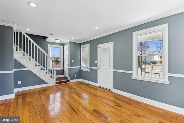 foyer featuring recessed lighting, baseboards, ornamental molding, stairway, and wood-type flooring