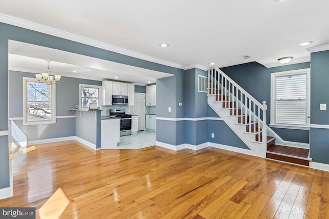 unfurnished living room featuring crown molding, stairway, baseboards, and light wood-style floors