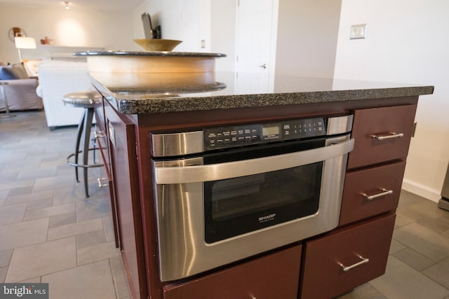 kitchen featuring oven, a breakfast bar, and a center island