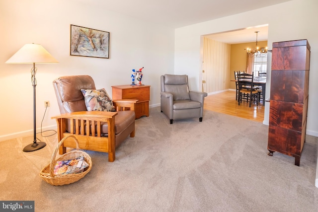 living area featuring an inviting chandelier and light colored carpet