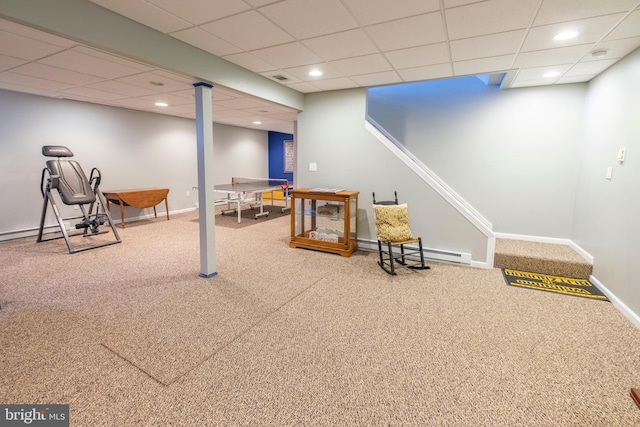 interior space featuring a drop ceiling, carpet flooring, and baseboard heating