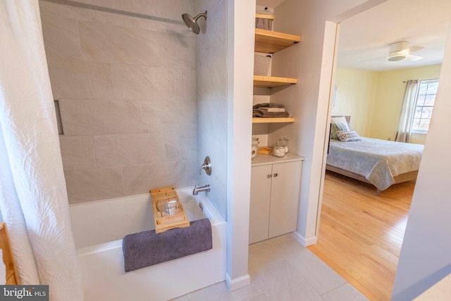 bathroom featuring shower / bathtub combination with curtain and hardwood / wood-style floors