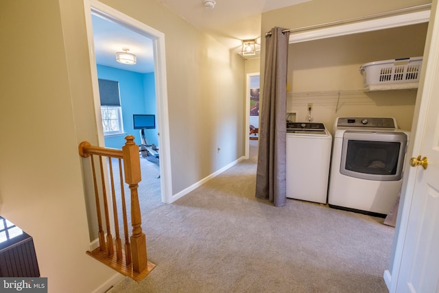 washroom featuring washer and clothes dryer and light colored carpet