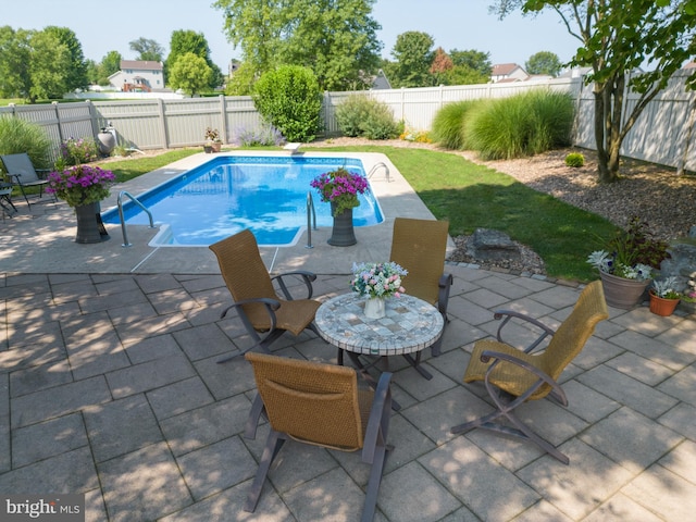 view of swimming pool with a patio area