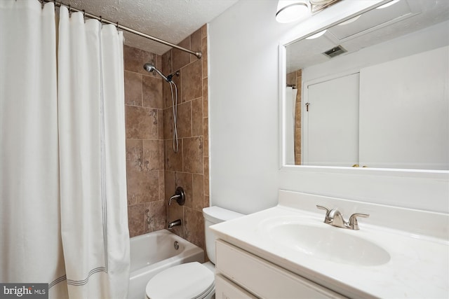 full bathroom with vanity, shower / tub combo, toilet, and a textured ceiling