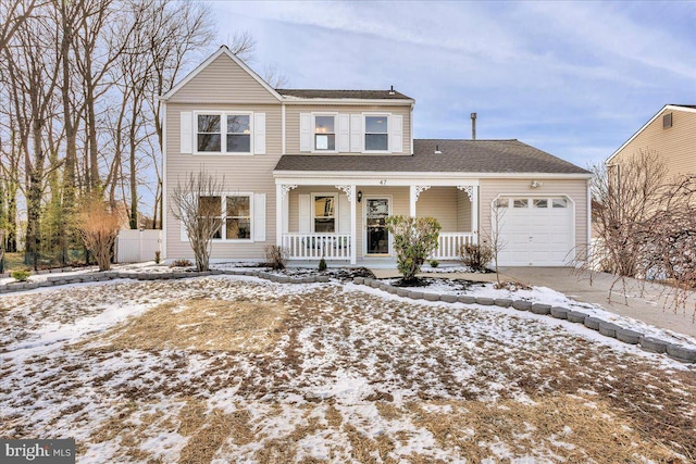 view of property featuring a porch and a garage