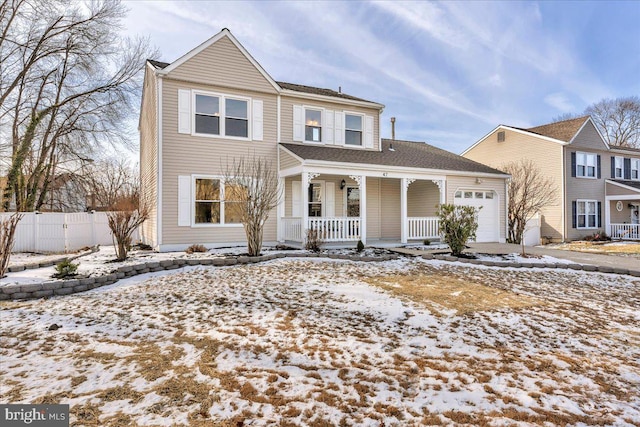 view of front property with a porch and a garage