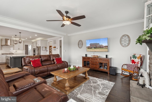 living room with ornamental molding, dark hardwood / wood-style floors, and ceiling fan