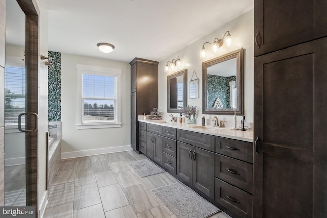 bathroom with vanity and shower with separate bathtub