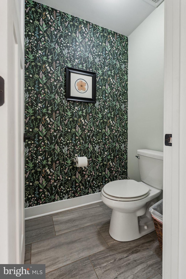 bathroom featuring hardwood / wood-style flooring and toilet