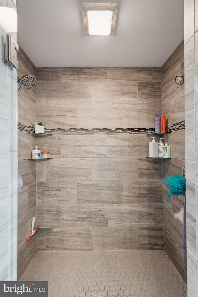 bathroom with tiled shower