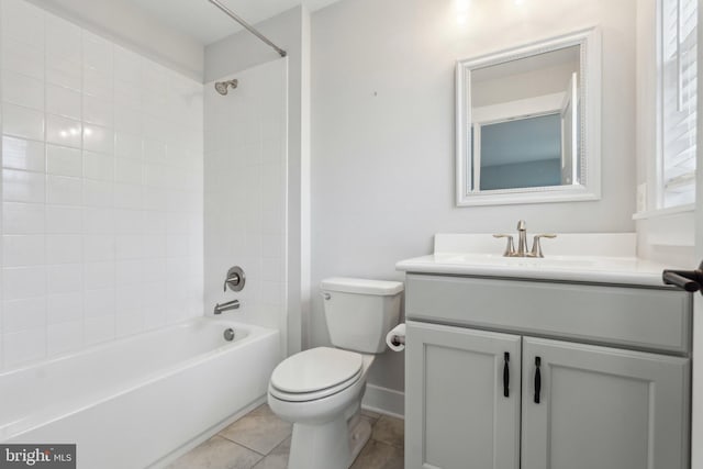 full bathroom featuring vanity, tile patterned floors, toilet, and tiled shower / bath