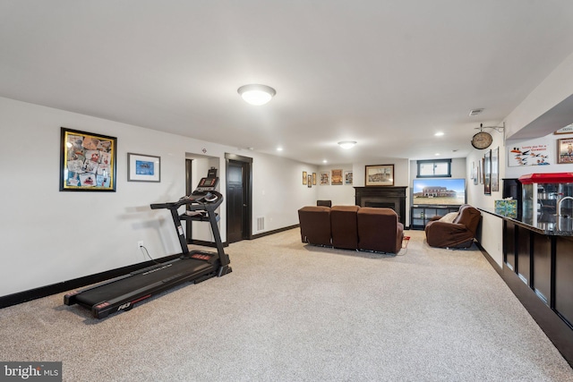 workout area featuring light colored carpet