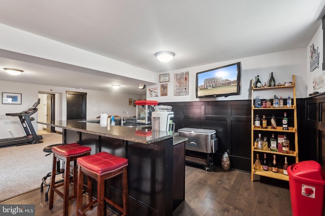 bar with sink and dark hardwood / wood-style floors