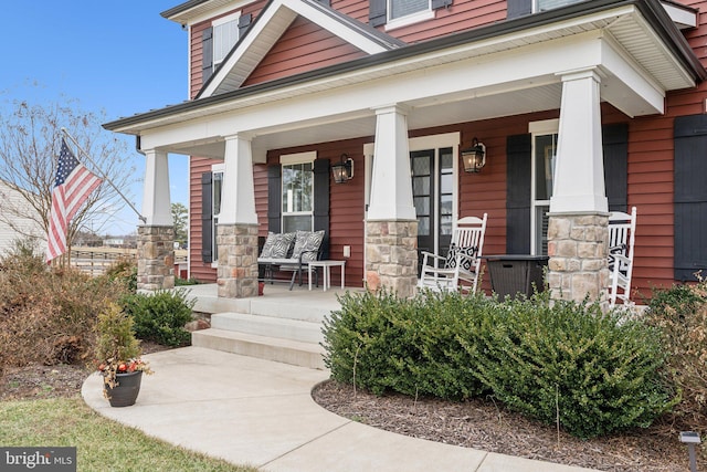 view of exterior entry with a porch