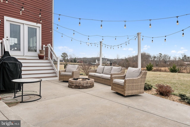 view of patio with area for grilling and an outdoor living space with a fire pit