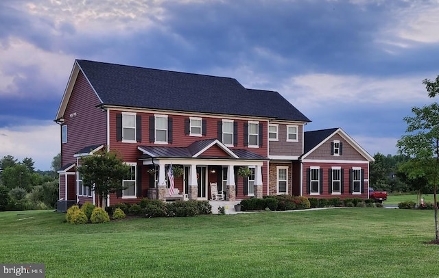 colonial home with a front lawn and covered porch