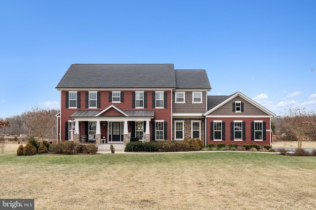 colonial home with a front yard and a porch