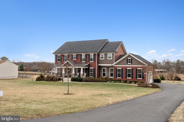 colonial house featuring a front yard