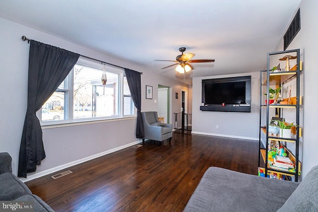 living room with dark hardwood / wood-style floors and ceiling fan