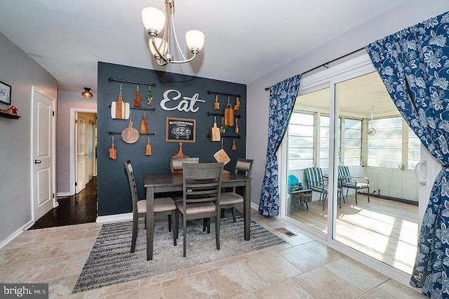 dining space with a notable chandelier