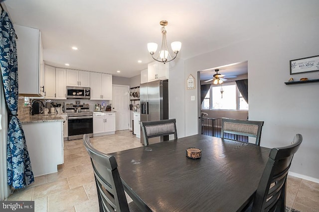 dining area with ceiling fan with notable chandelier