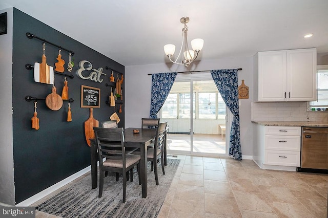 dining area featuring an inviting chandelier