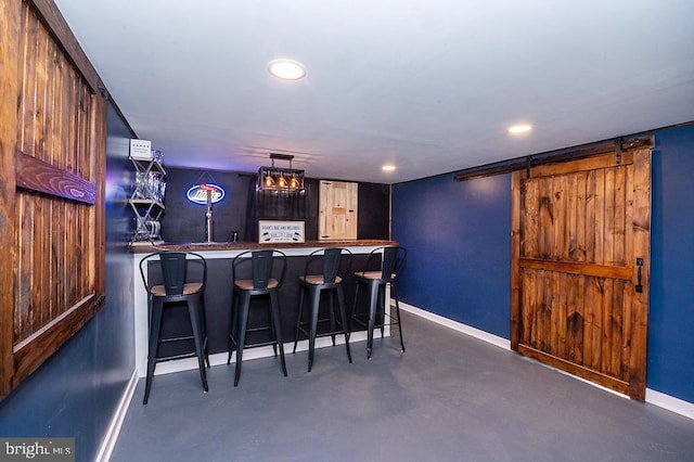 bar featuring a barn door and pendant lighting