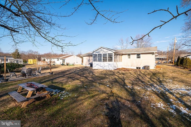 back of house featuring a yard