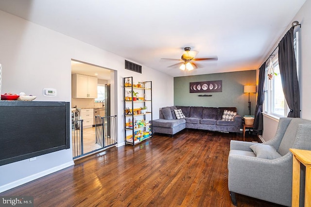 living room featuring dark hardwood / wood-style floors and ceiling fan