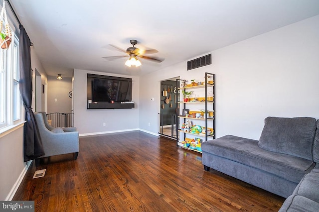 sitting room with dark hardwood / wood-style floors and ceiling fan