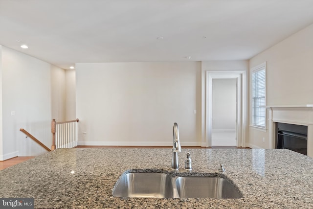 kitchen with sink and light stone counters