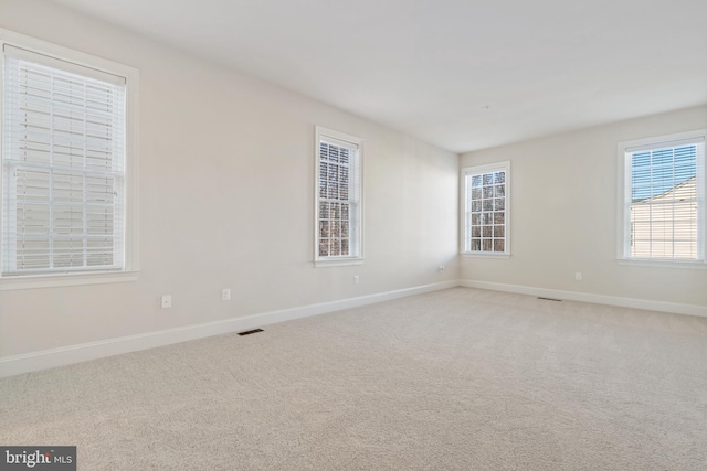 spare room with light colored carpet