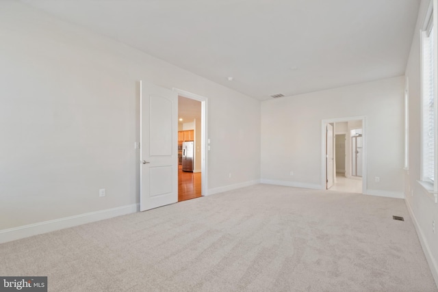 empty room featuring light colored carpet