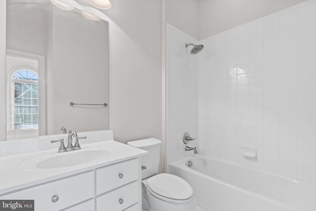 full bathroom with vanity, tiled shower / bath combo, and toilet