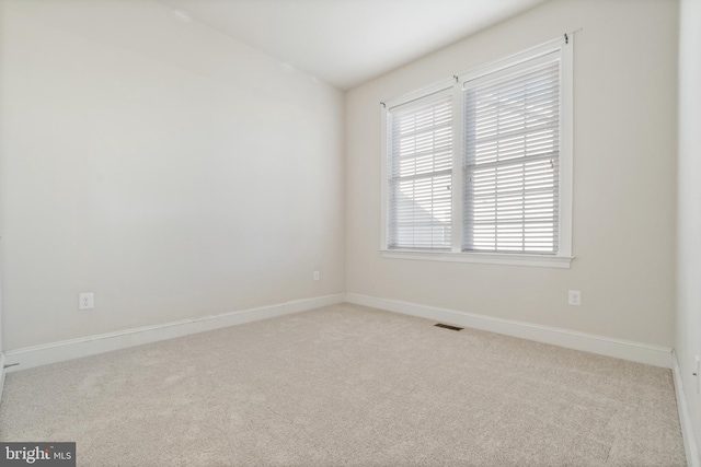 empty room with light colored carpet