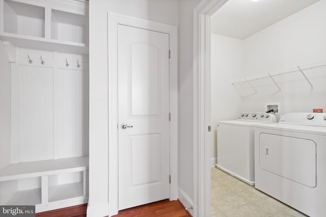 clothes washing area with washer and clothes dryer