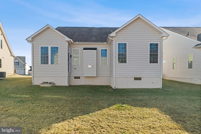 back of property featuring cooling unit and a lawn