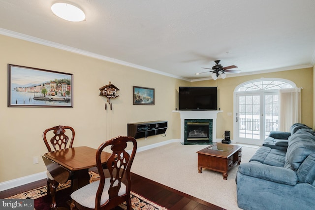 living room featuring ornamental molding, ceiling fan, and wood-type flooring