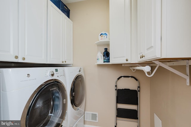 laundry area featuring cabinets and independent washer and dryer