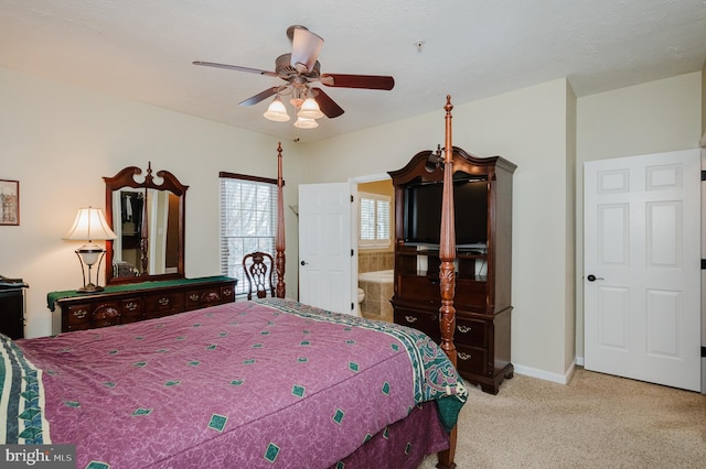 carpeted bedroom with ceiling fan and connected bathroom