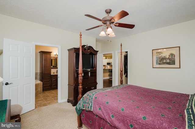 carpeted bedroom featuring ceiling fan and connected bathroom