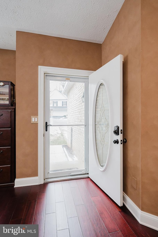 entryway with a textured ceiling