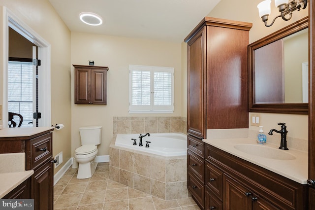 bathroom featuring a relaxing tiled tub, tile patterned floors, a wealth of natural light, and vanity