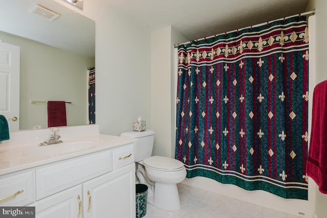 bathroom featuring toilet, a textured ceiling, tile patterned floors, and vanity