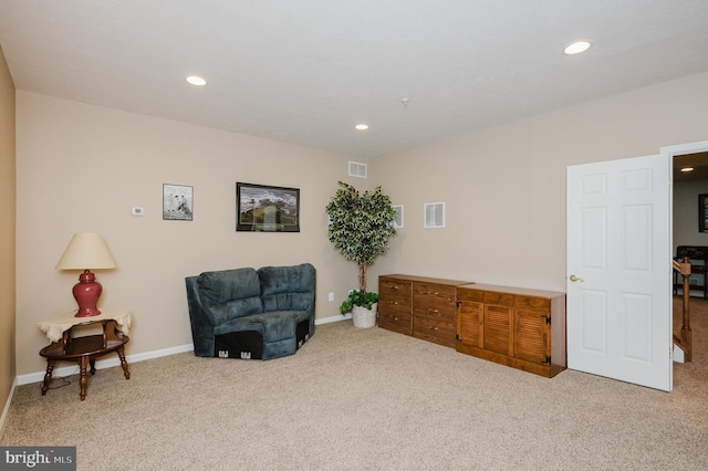 living area with light carpet