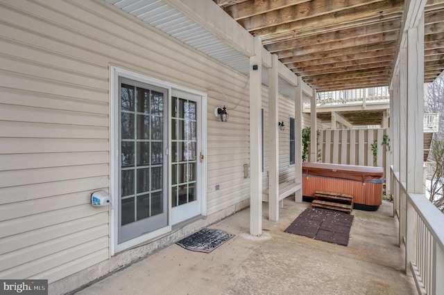 view of patio / terrace with a hot tub