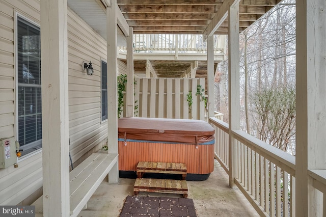 wooden deck with a hot tub