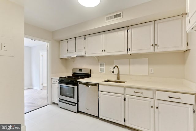 kitchen featuring white cabinetry, sink, and appliances with stainless steel finishes