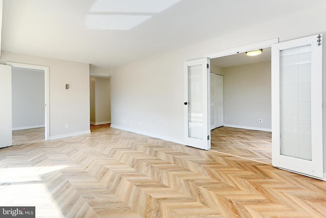 unfurnished room featuring light parquet flooring and french doors